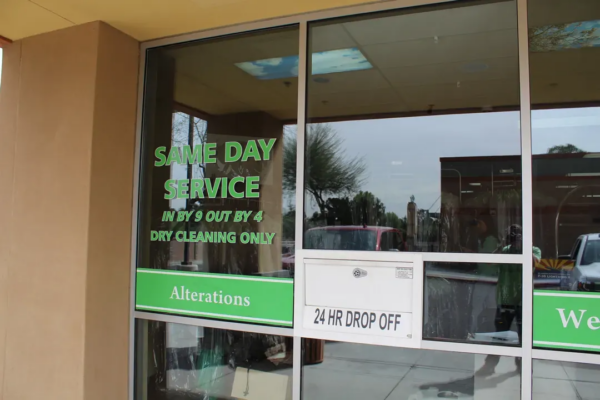 Green Cleaners Litchfield Park storefront window with the same-day service and 24-hour drop-off sign
